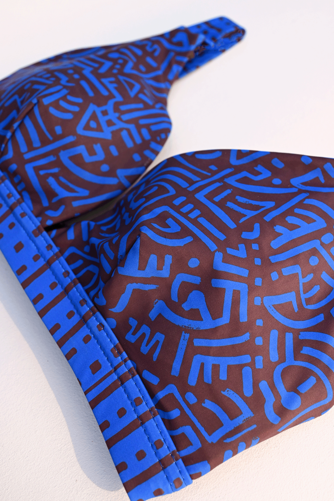 Electric blue & brown two-piece costume closeup photograph