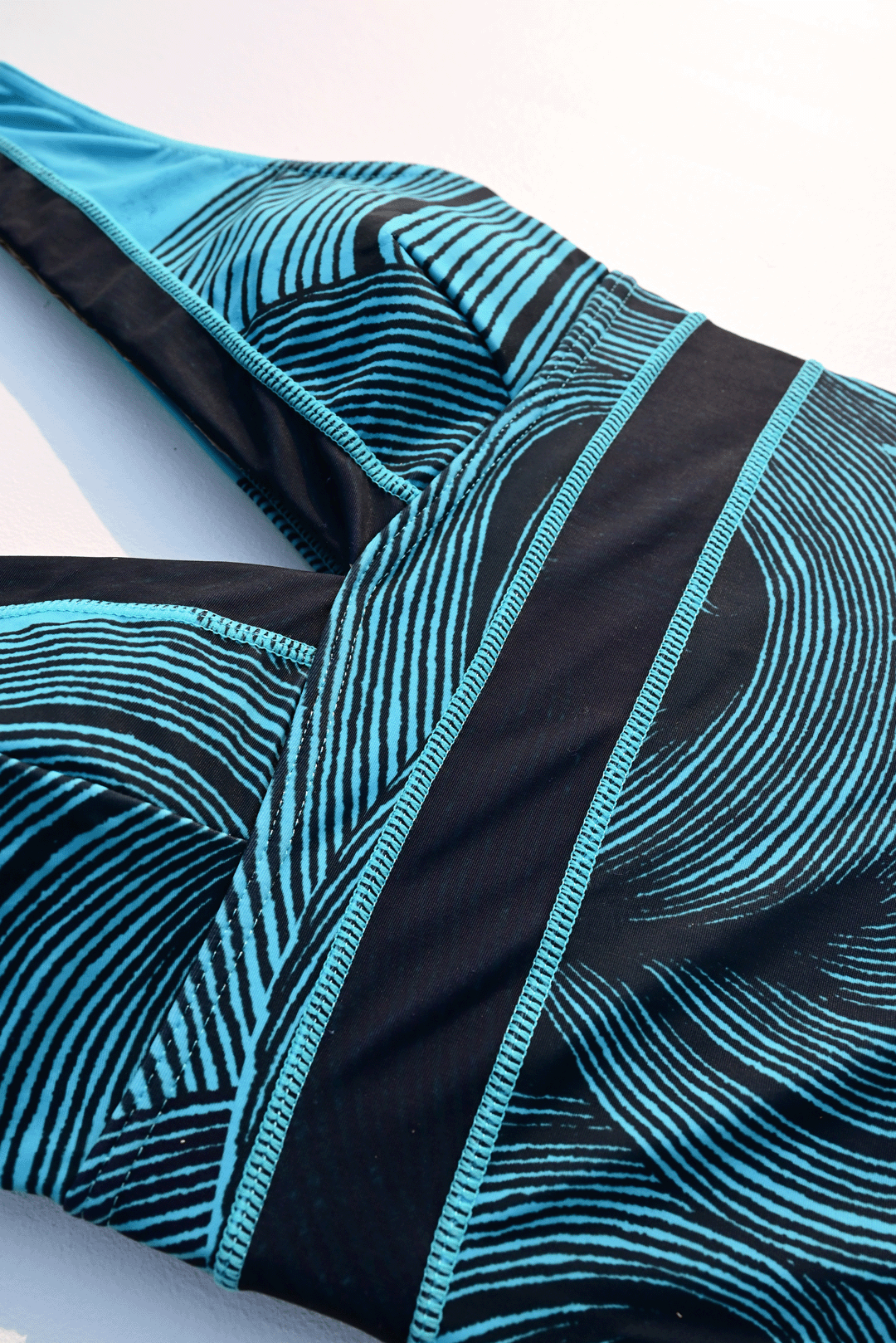 Black & Blue one-piece costume closeup photograph