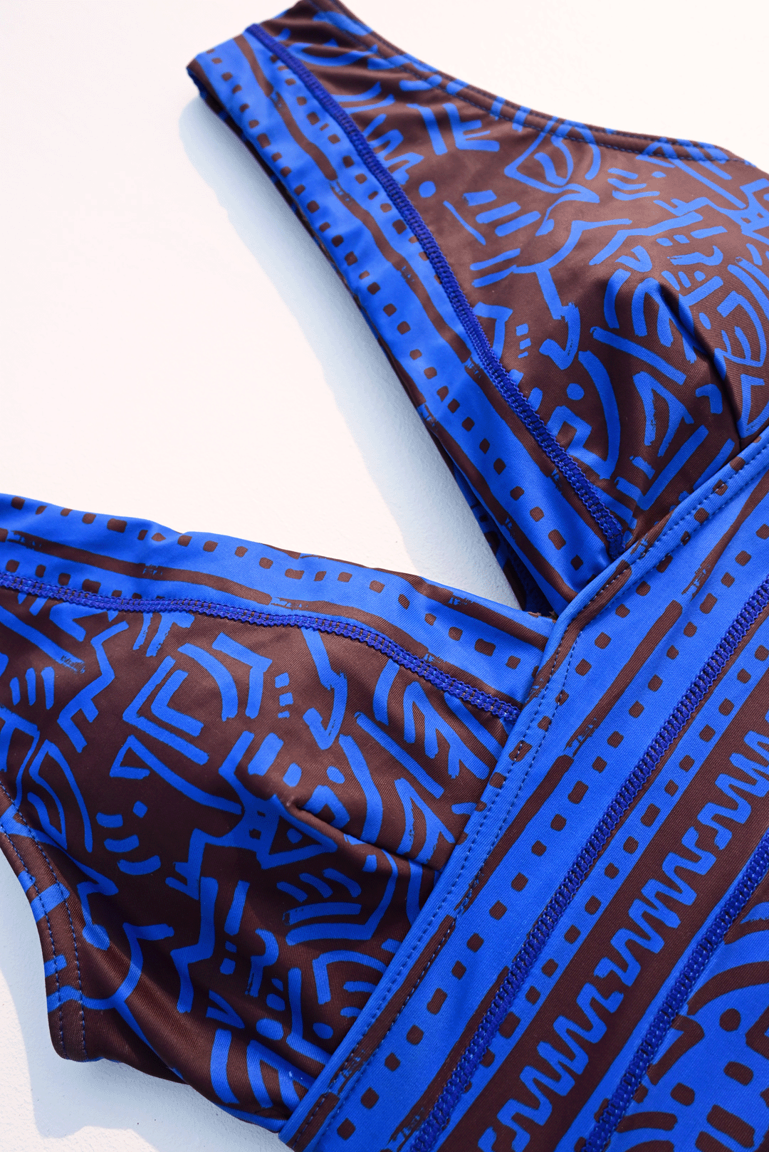 Electric blue & brown one-pice costume closeup photograph