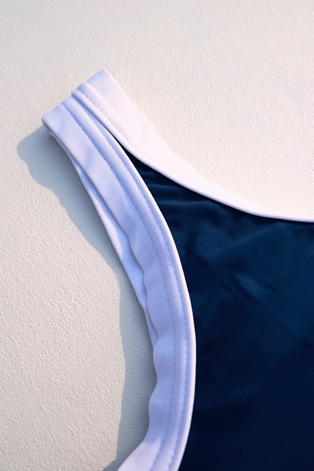 Navy blue & white one-piece costume closeup photograph