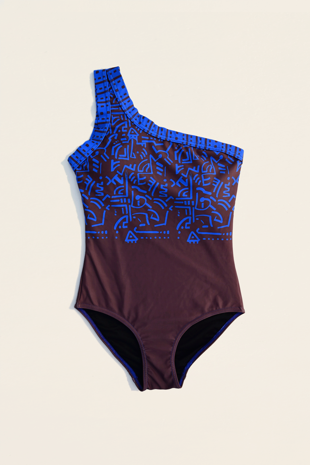 Electric blue & brown one-piece costume flat-lay photograph