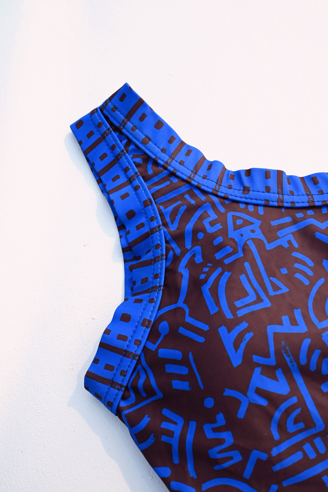 Electric blue & brown one-piece costume closeup photograph