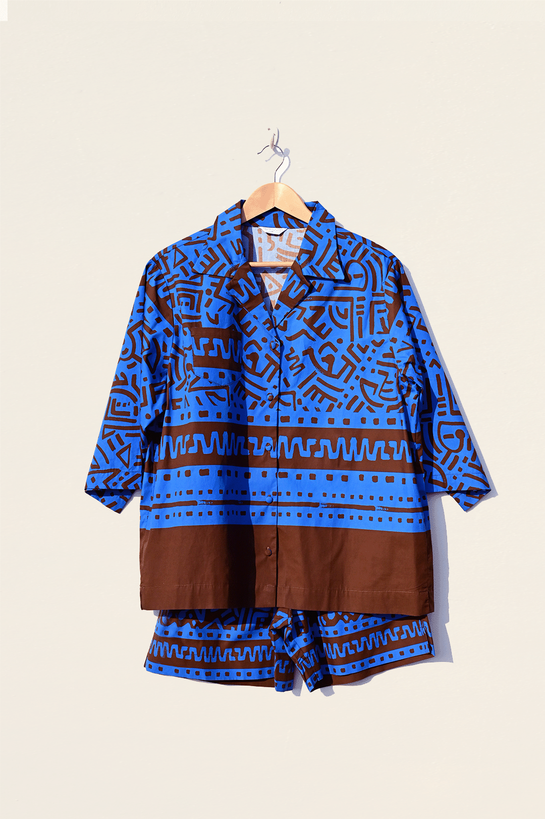 Electric blue & brown shirt & pants set hanging photograph